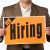 Businessman holding Now Hiring sign