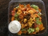 Taco on a plate... Crushed nacho flavored chips taco meat lettuce tomatoes onions, melted nacho cheese and sour cream